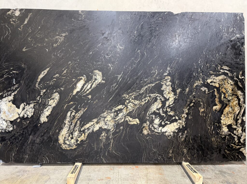 Elevate your space with the bold elegance of Titanium Gold Granite. Dramatic black swirling with warm gold—pure luxury for your home