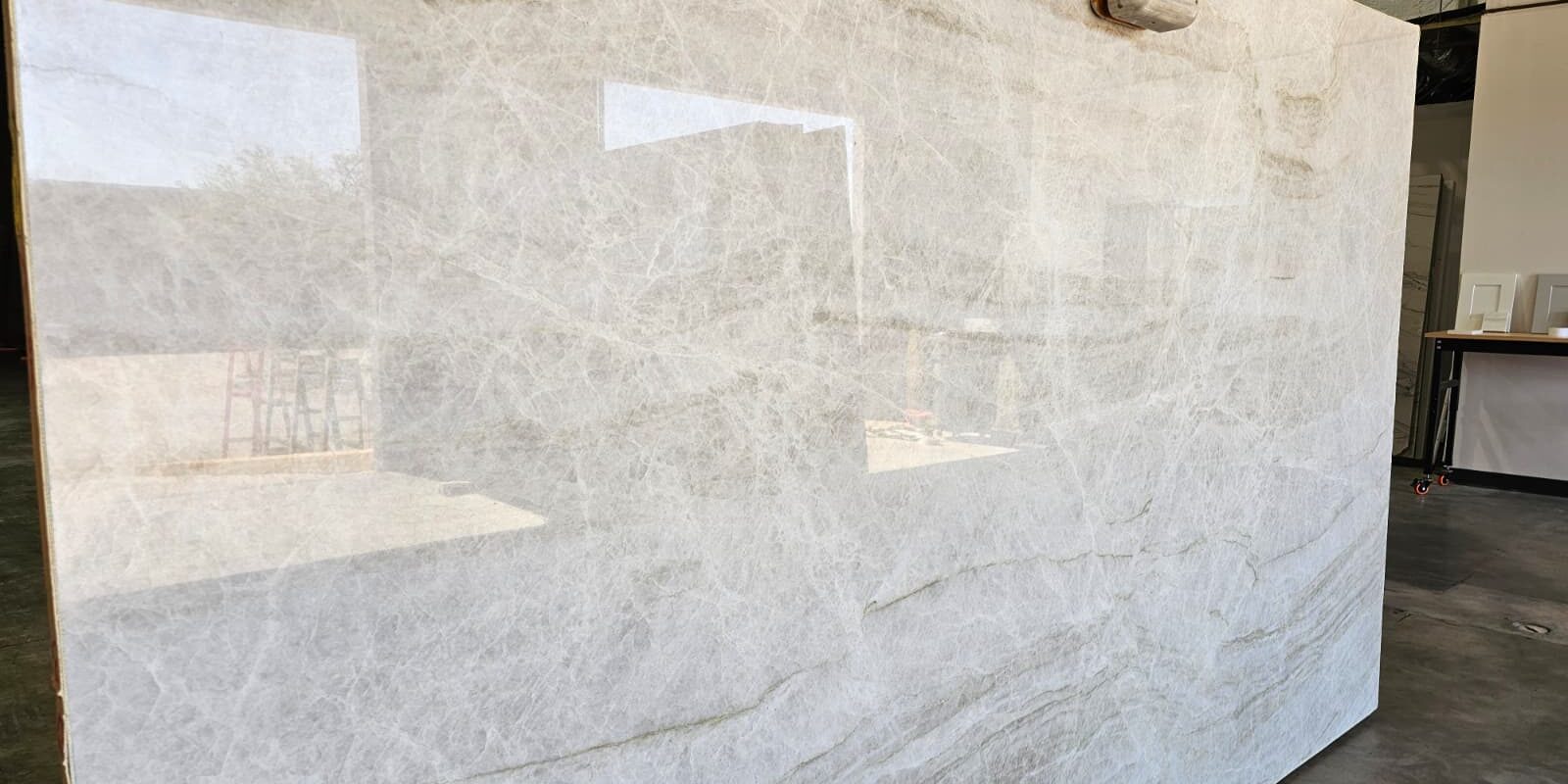 Polished full slab view showing the consistent tonal harmony of the cream and taupe palette.