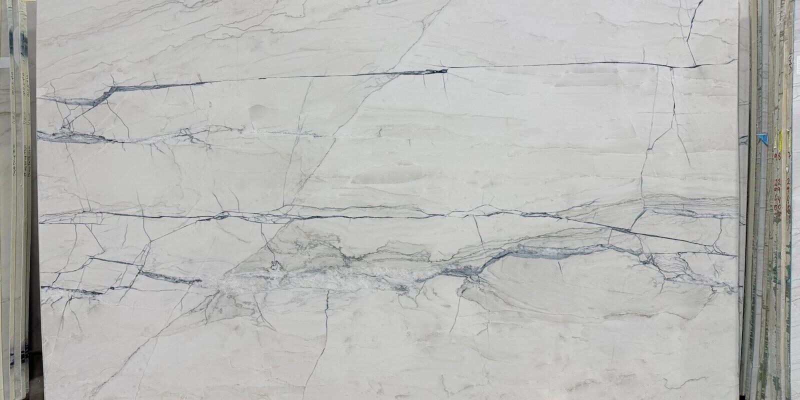A large-format Fantasy Lux Quartzite with high-contrast grey veins, ideal for book-matched installations.