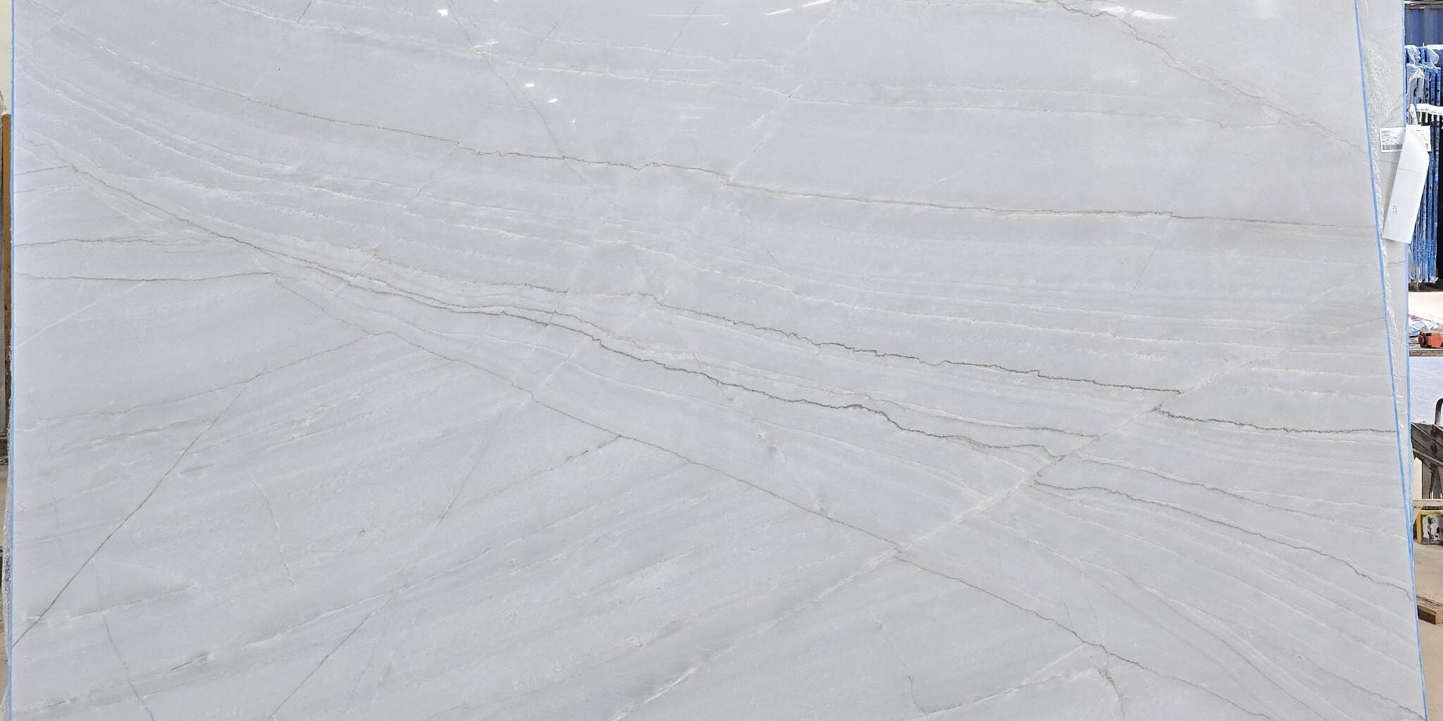 Premium slab of Azzurra Bay showing a consistent white canvas and linear grey threads.