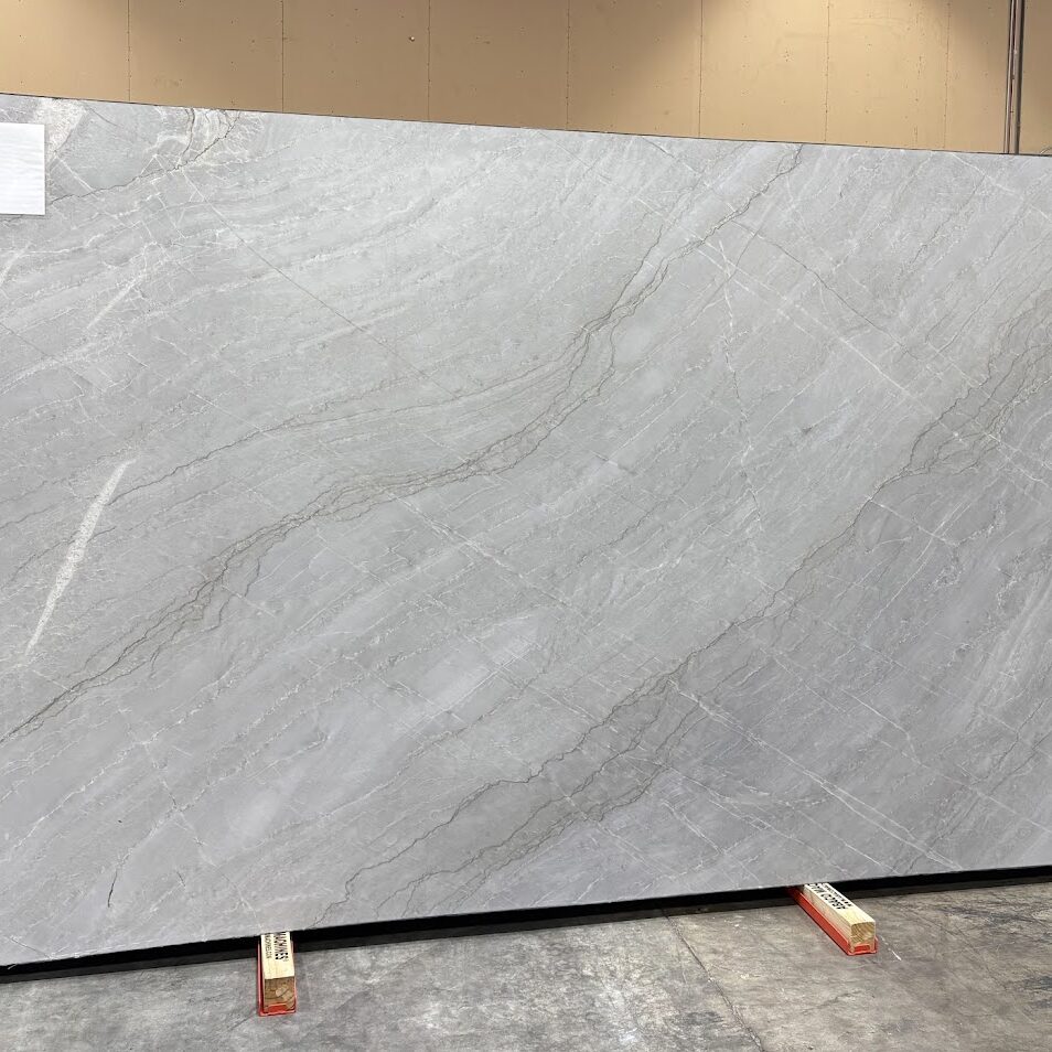 Full view of a quartzite slab showing its graceful, rhythmic grey veining.