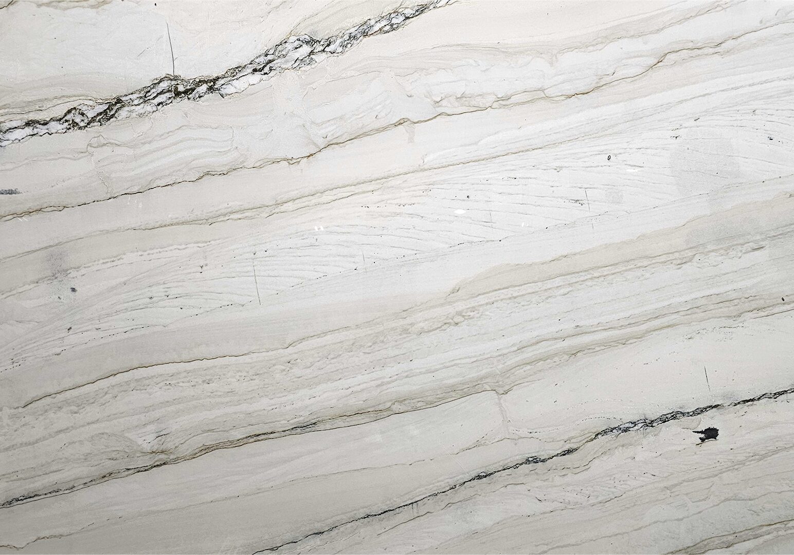 Bellagio quartzite natural stone slab featuring creamy white and beige tones with delicate flowing veining for luxury interior design.