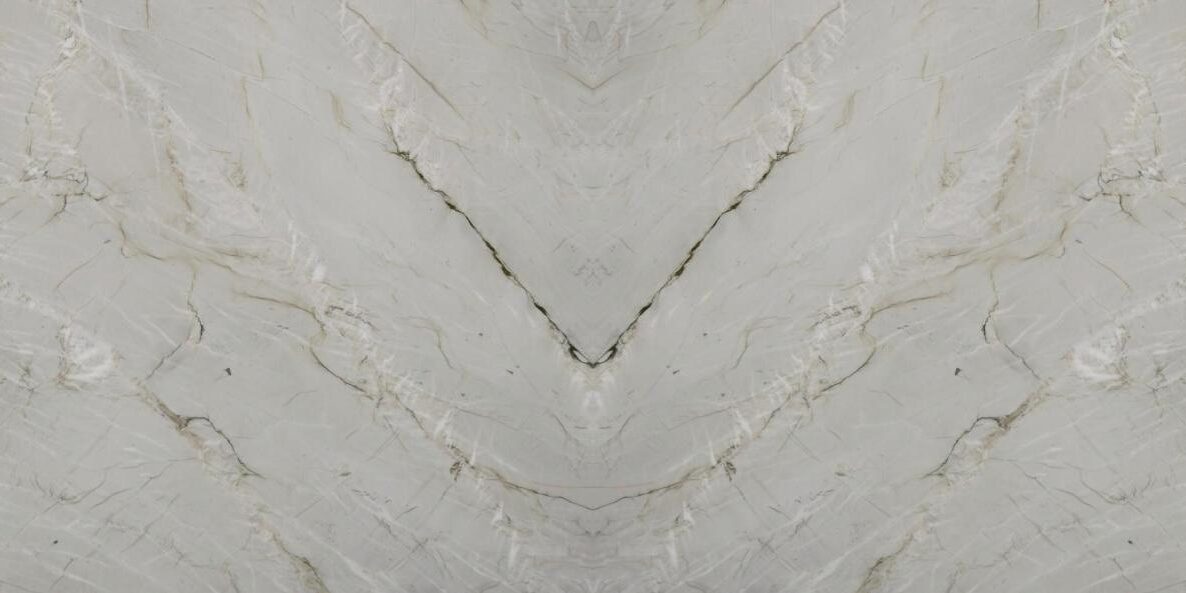 Detailed shot of a high-quality Bianco Superiore quartzite slab with polished finish, highlighting the natural beauty of the rock structure and mineral lines.