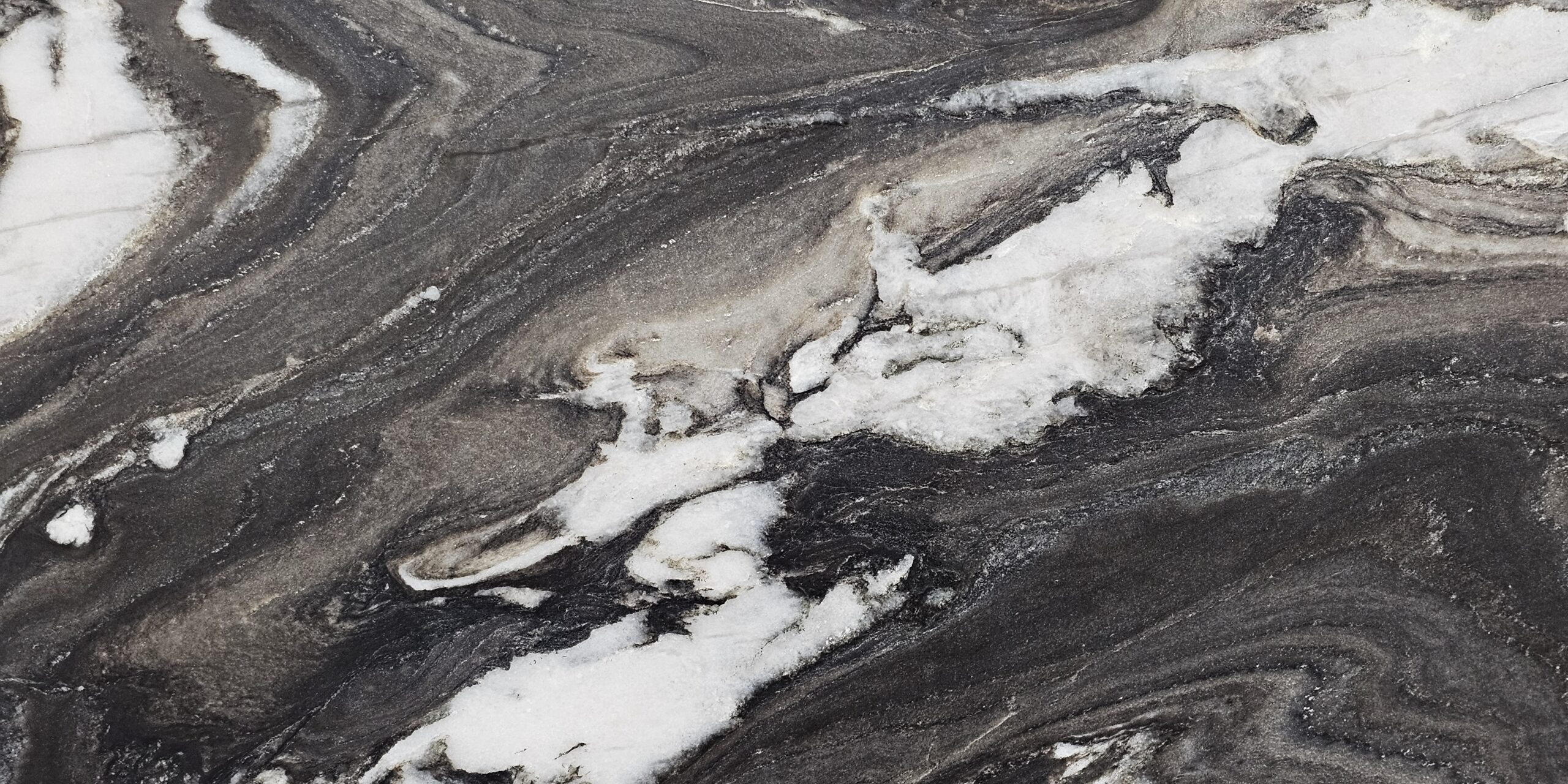 Macro shot of the textured surface and organic mineral layers of a leathered natural stone.