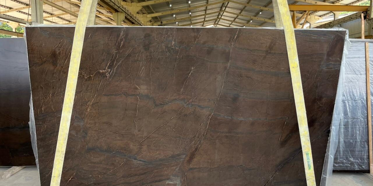 Large format dark brown natural stone slab for luxury interior fabrication.