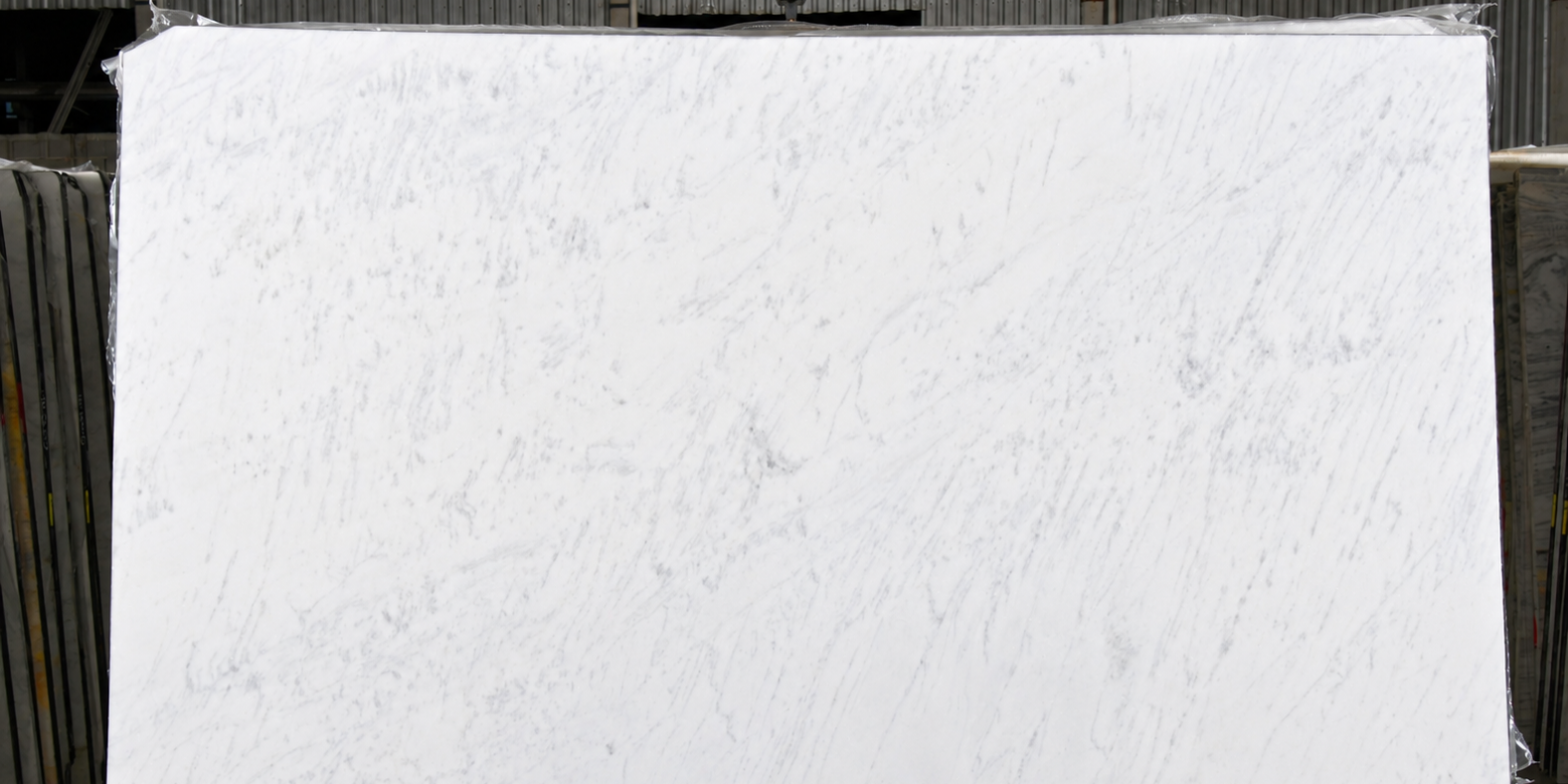An open-faced natural marble slab showcasing elegant, light-reflective surfaces for luxury architectural projects.