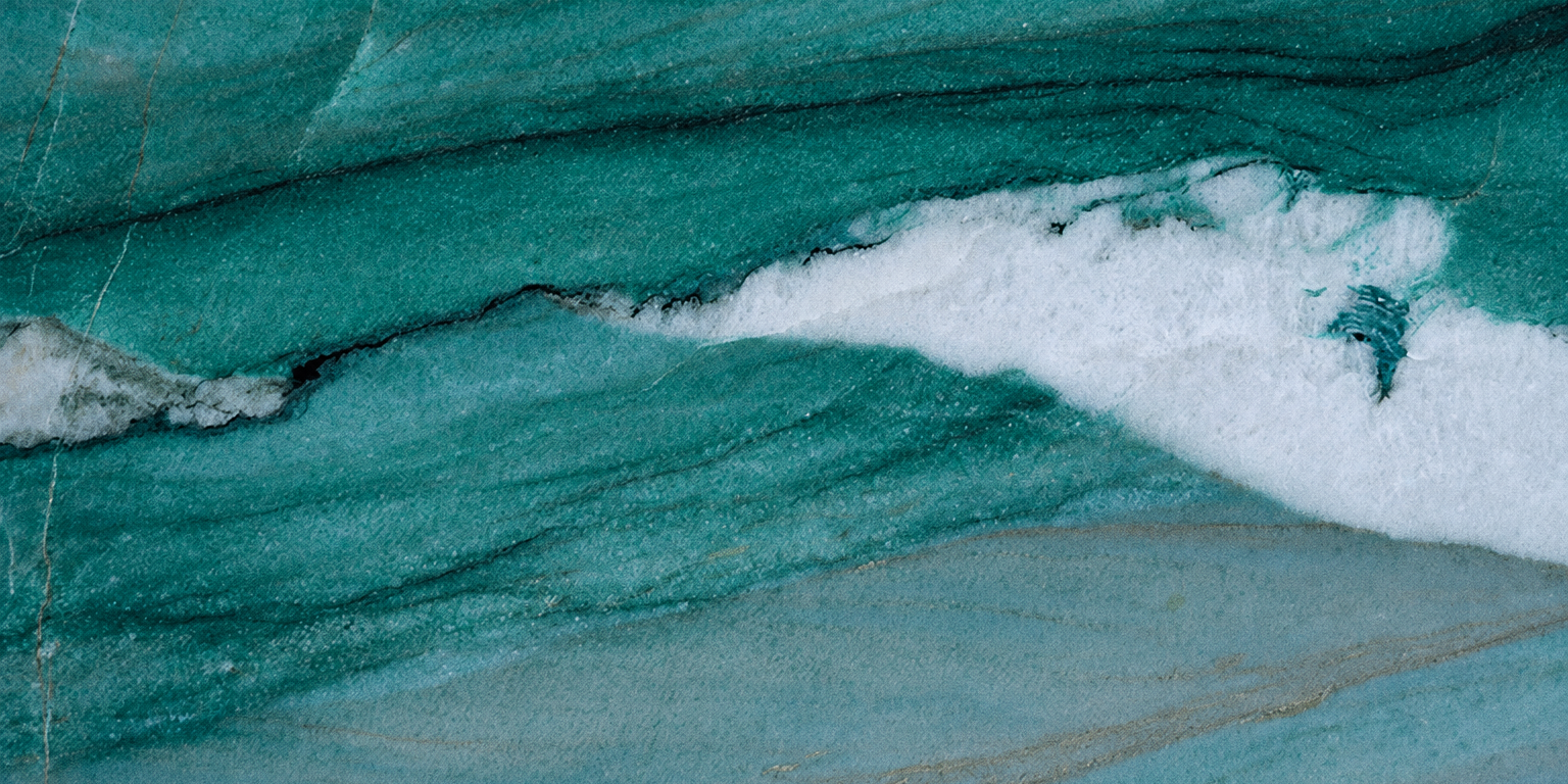 A macro view highlighting the crystalline blue kyanite formations and shimmering white quartz veins within a Mocamblu slab.