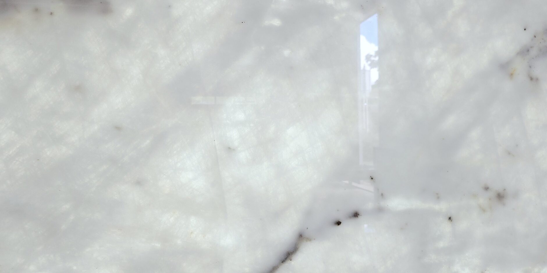 Extreme close-up of the crystalline texture and amber veining of a high-end natural stone.