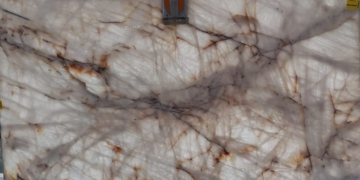 High-quality white and gold natural stone slab, perfect for backlit architectural features.