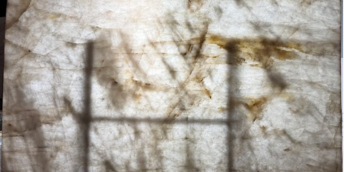 Dramatic view of a backlit slab highlighting its unique amber-toned crystalline structure.