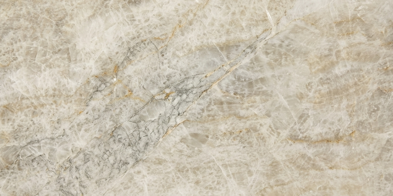 A detailed macro shot capturing the soft ivory background and subtle crystalline veins of a premium natural stone slab.