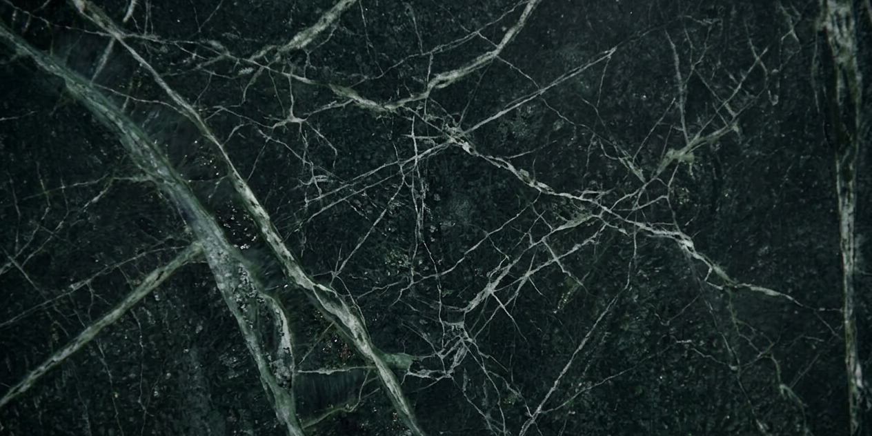 A detailed macro view of the deep emerald crystals and erratic slate veining of a premium Brazilian stone.