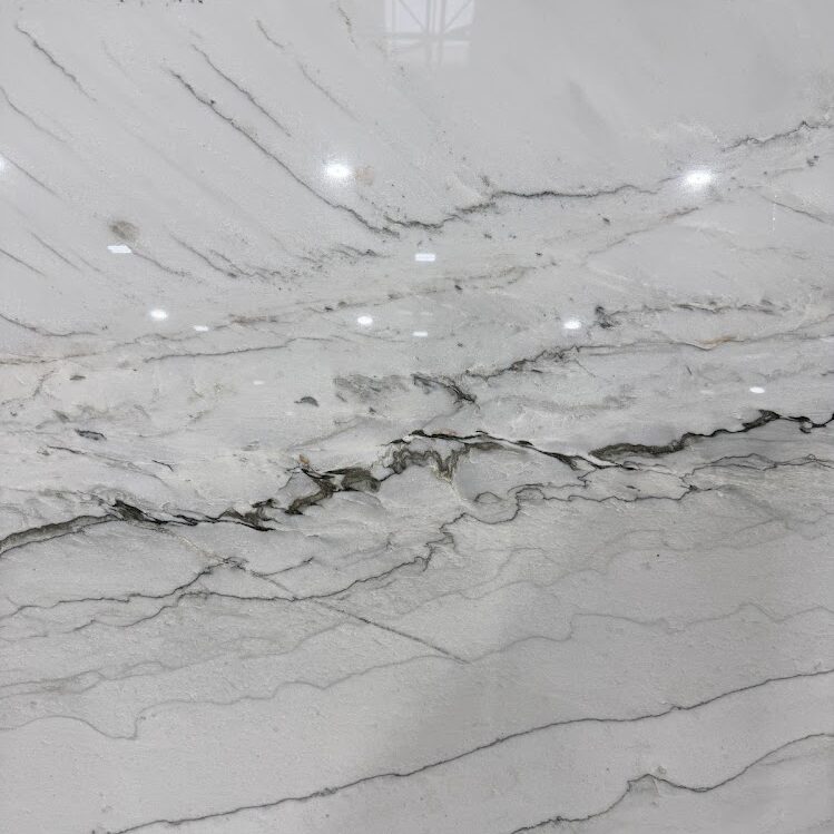 Close-up detail of the soft gray and blue veining on an Infinity White Quartzite surface.