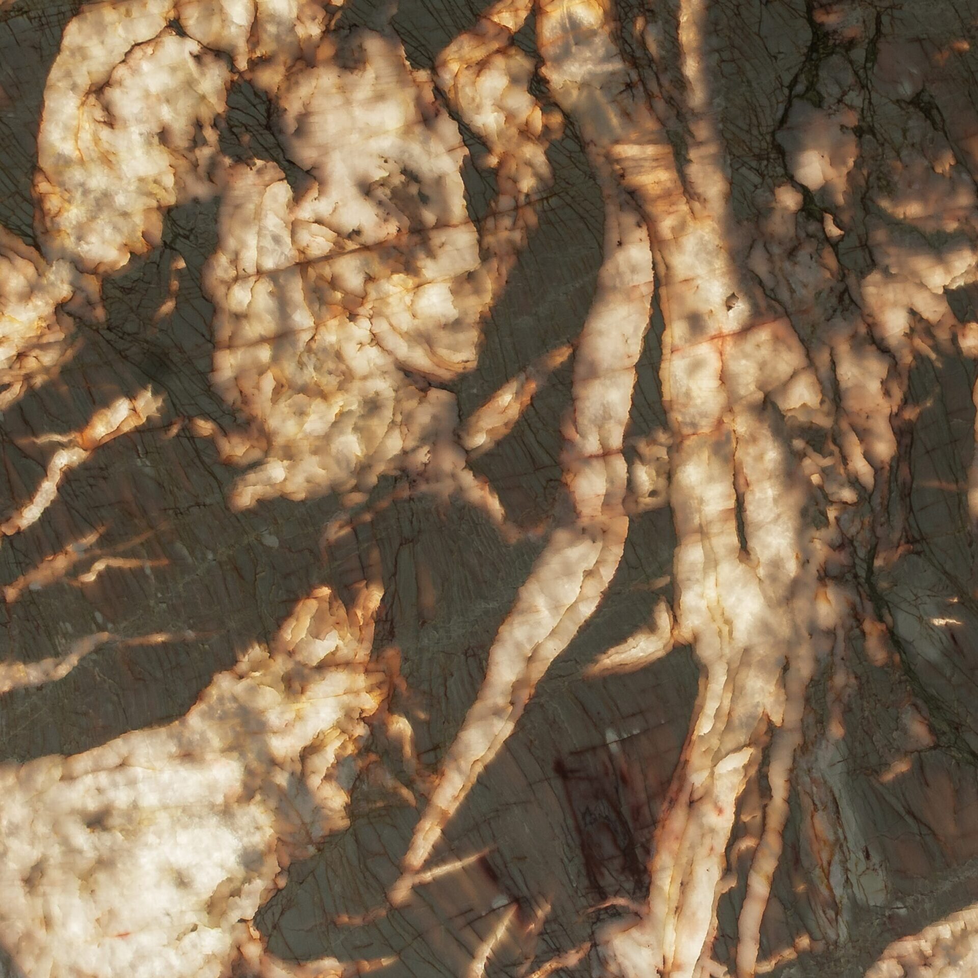 Macro detail of translucent quartzite under illumination, highlighting the glowing golden-rust fissure patterns within the crystalline stone structure.