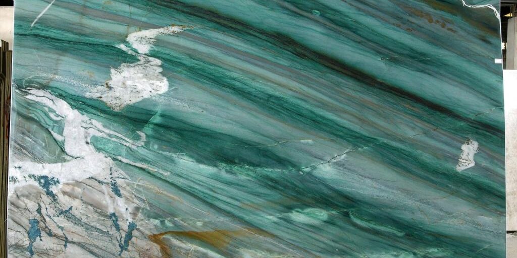 Full view of a polished Mocamblu quartzite slab showcasing its spectacular diagonal movement and deep teal and green hues.