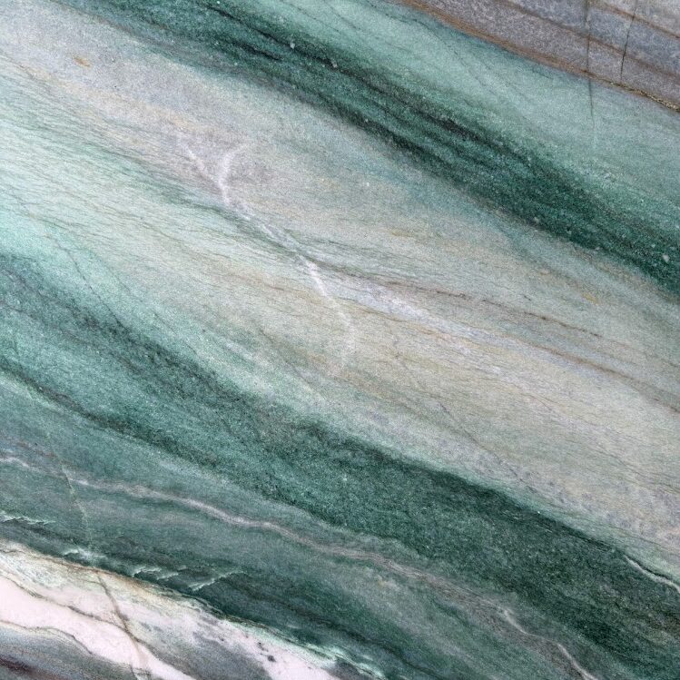 Detailed close-up focusing on the rich, textured green fuchsite layers and earthy undertones of an exotic natural stone.