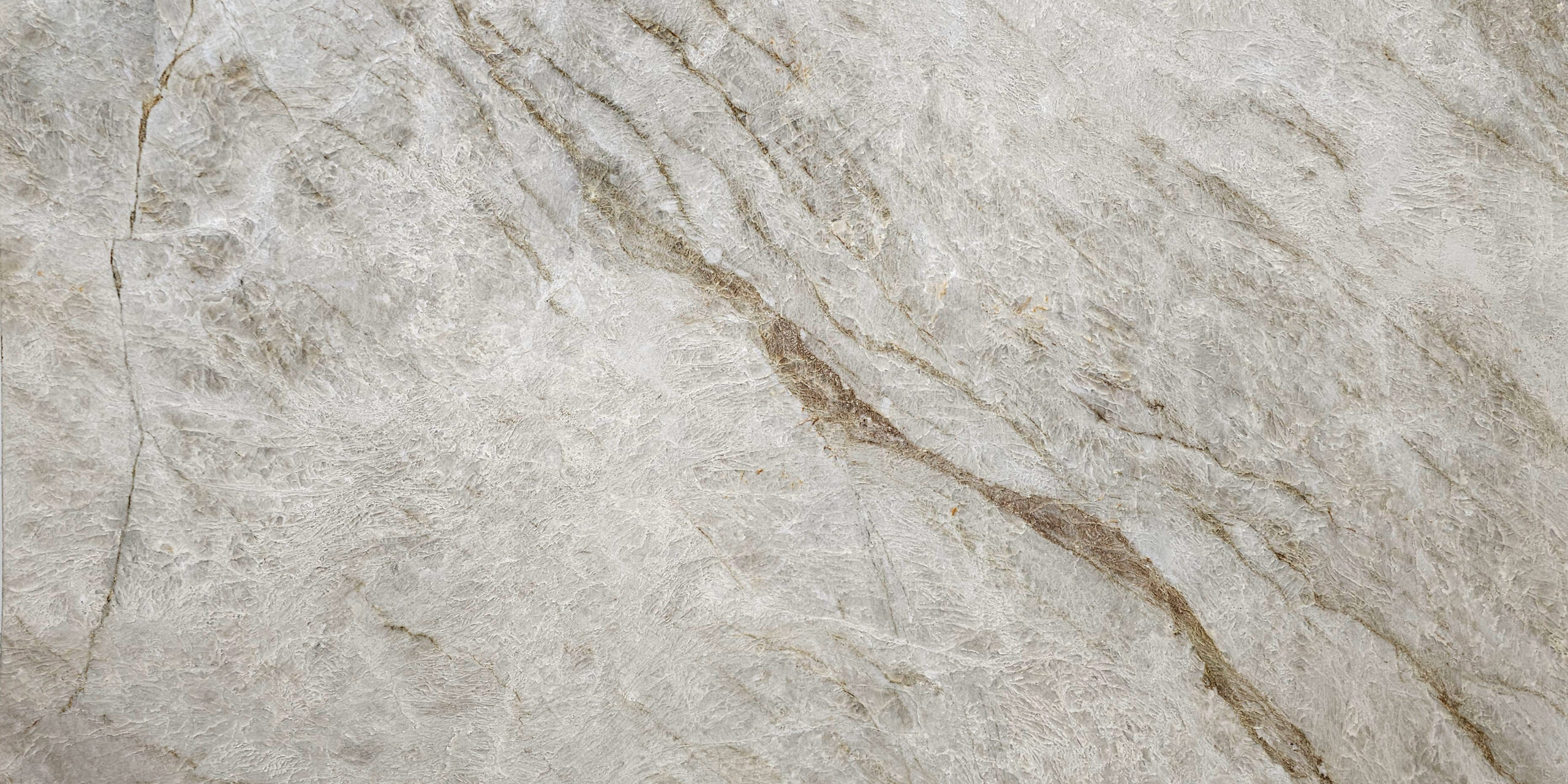 Full slab view of Naica Quartzite showcasing its elegant movement and bright, clean aesthetic.