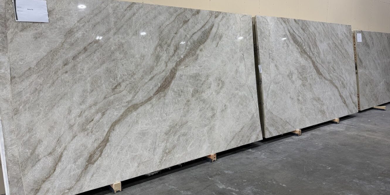 Two mirrored slabs of ivory quartzite creating a dramatic and symmetrical butterfly pattern for a wall feature.