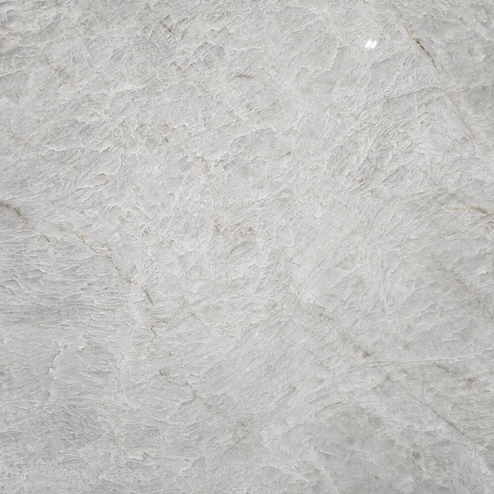 Extreme close-up of the creamy ivory texture and translucent crystalline details of Naica Quartzite.
