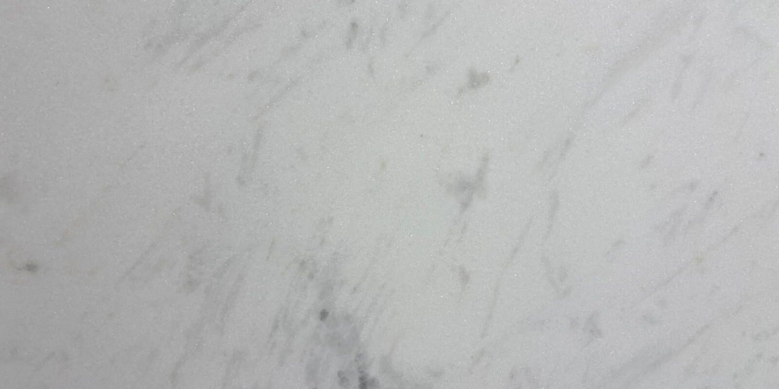 A detailed macro view of the crystalline structure and soft gray veining of a high-end natural stone.