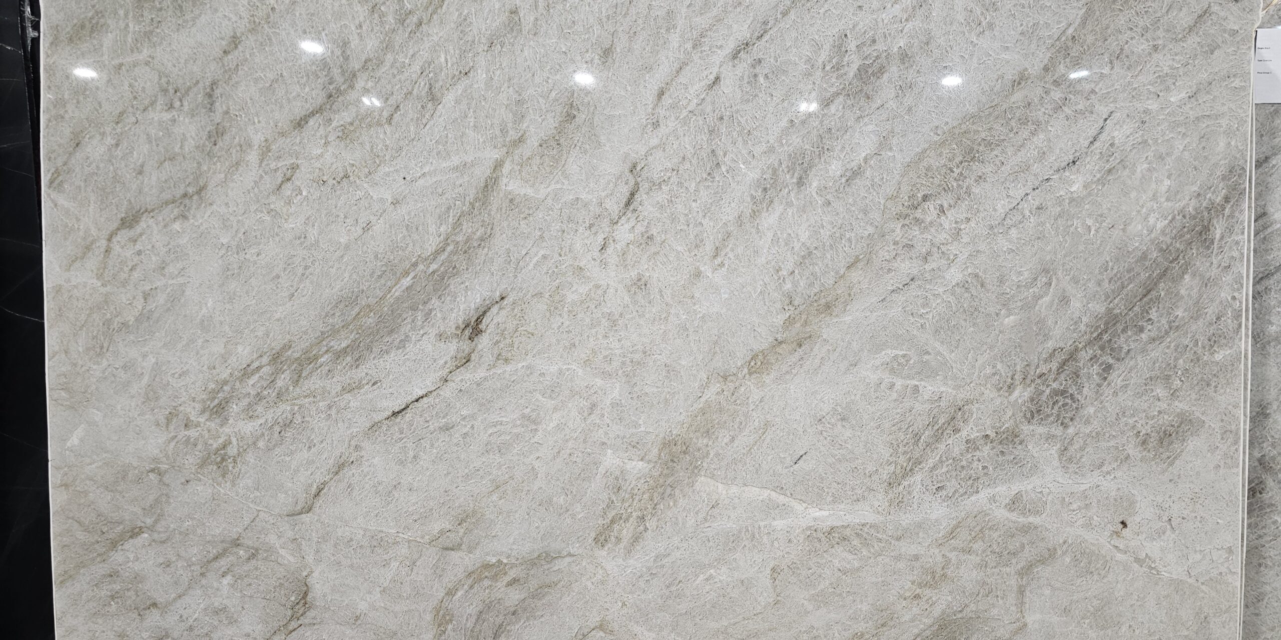 A large-format polished slab of Perla Rocca, ready for fabrication as quartzite countertops in Austin.