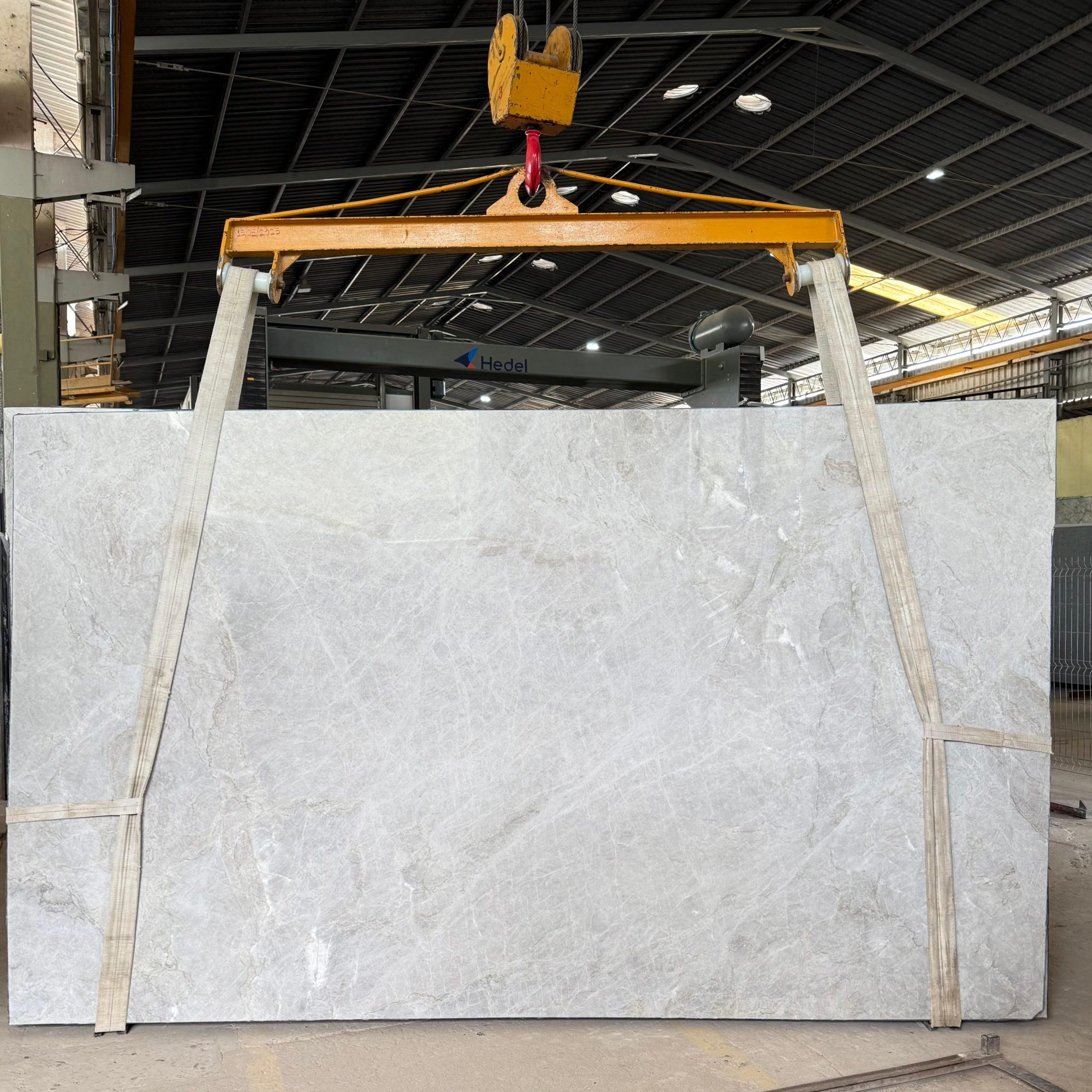 Full view of a Perla Venata Quartzite slab showcasing its elegant creamy white tones and gentle taupe movement.