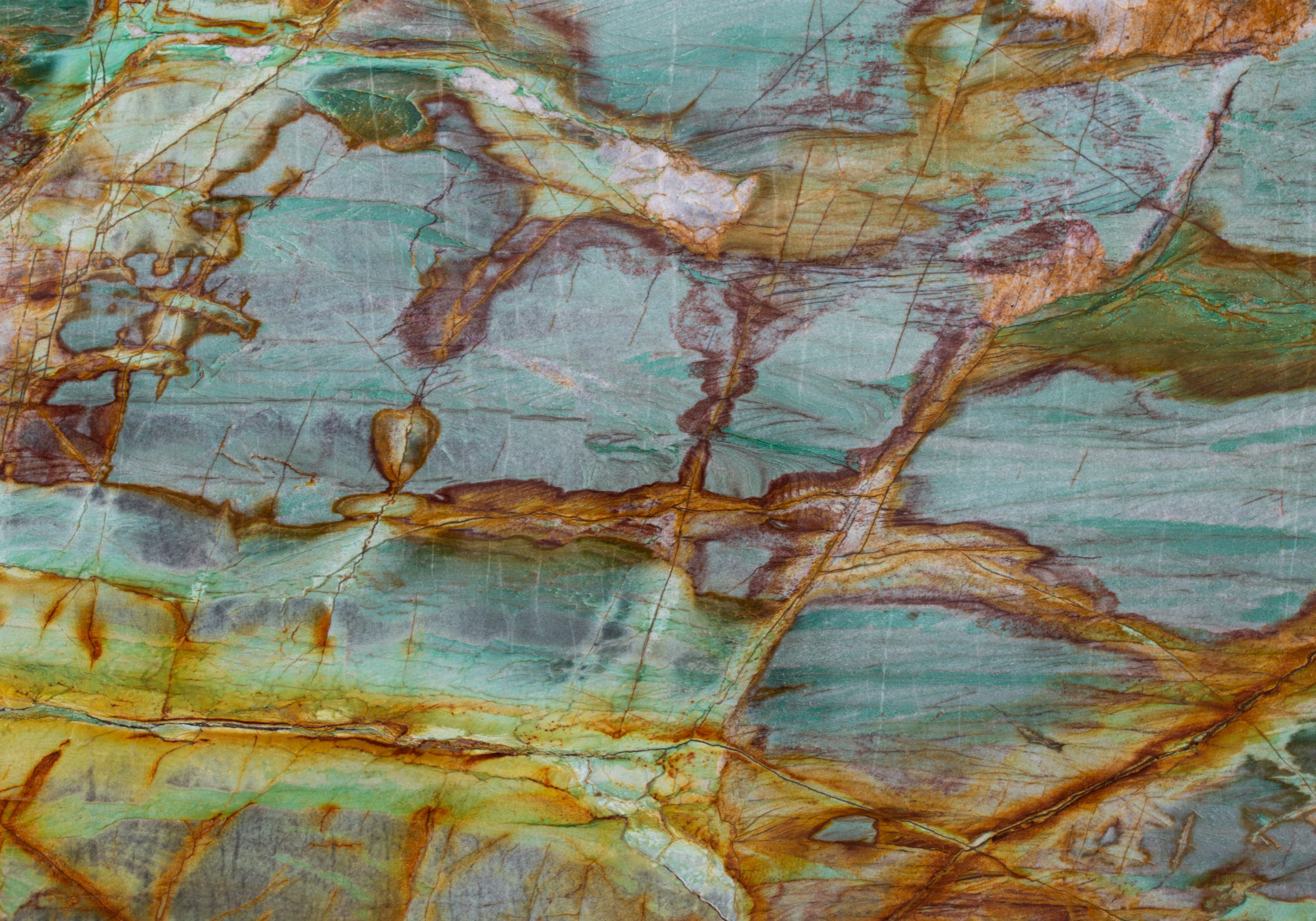 Tight focus on the intricate earthy brown threading and ivory patches within a polished quartzite slab.