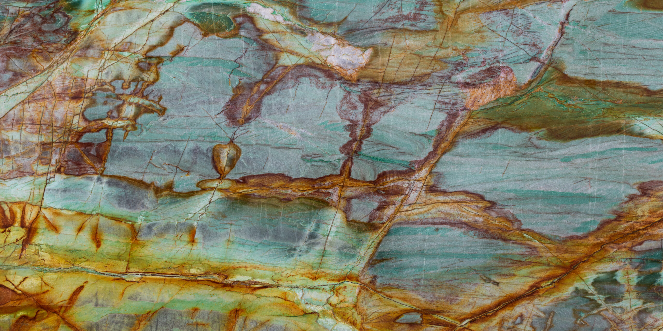 Tight focus on the intricate earthy brown threading and ivory patches within a polished quartzite slab.
