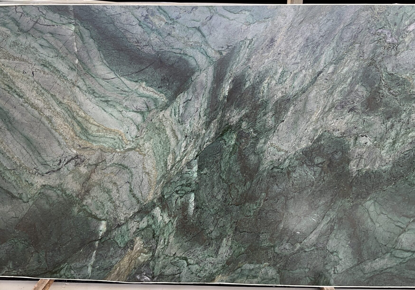 Full-size natural quartzite slab in deep forest green with golden and charcoal veining, ideal for luxury kitchen islands and statement feature walls.