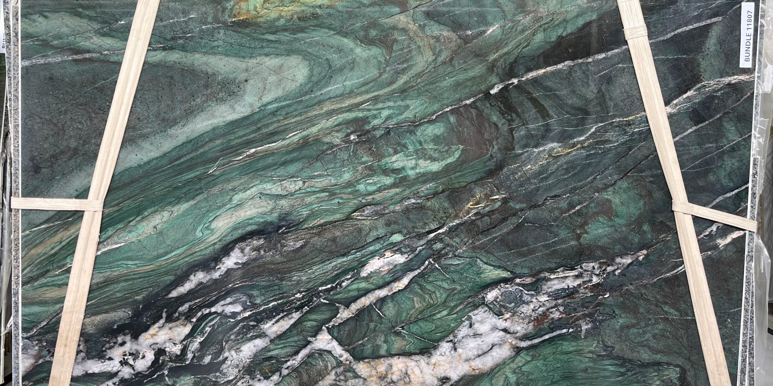 Full slab view of Sombori Island stone with dramatic ocean-like movement and silver accents.