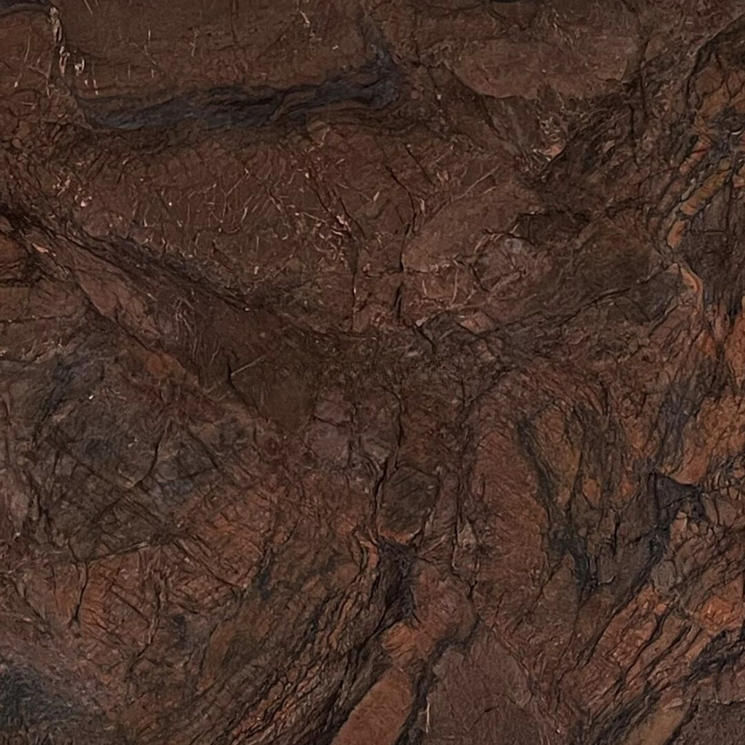 Macro view of Chivas quartzite showing deep brown textures and sharp copper-colored veins.