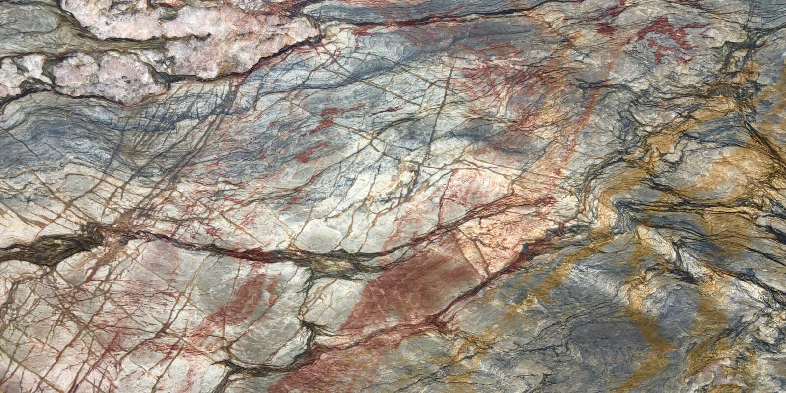 A detailed macro view of a Tempest Blue Quartzite slab highlighting its shimmering muscovite layers and deep red garnet inclusions.