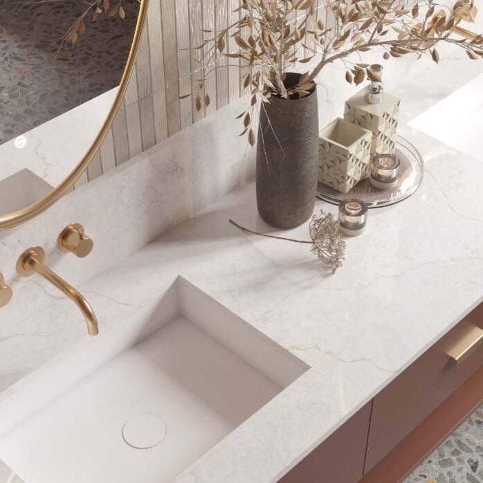 Modern bathroom interior with a custom-fabricated vanity top and integrated sink crafted from premium white stone with golden veining.