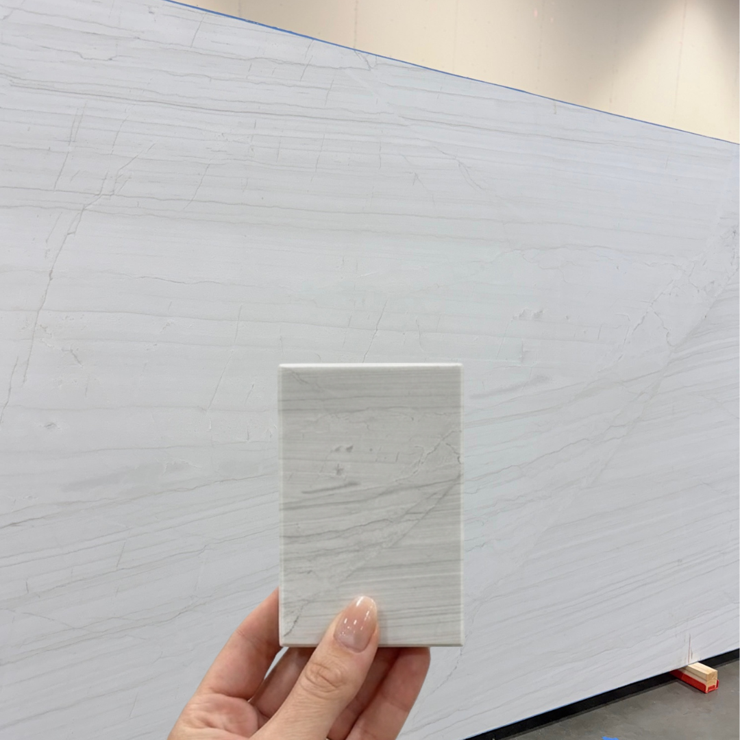 Details of the delicate grey veining and crystalline surface of a White Lux Quartzite slab.