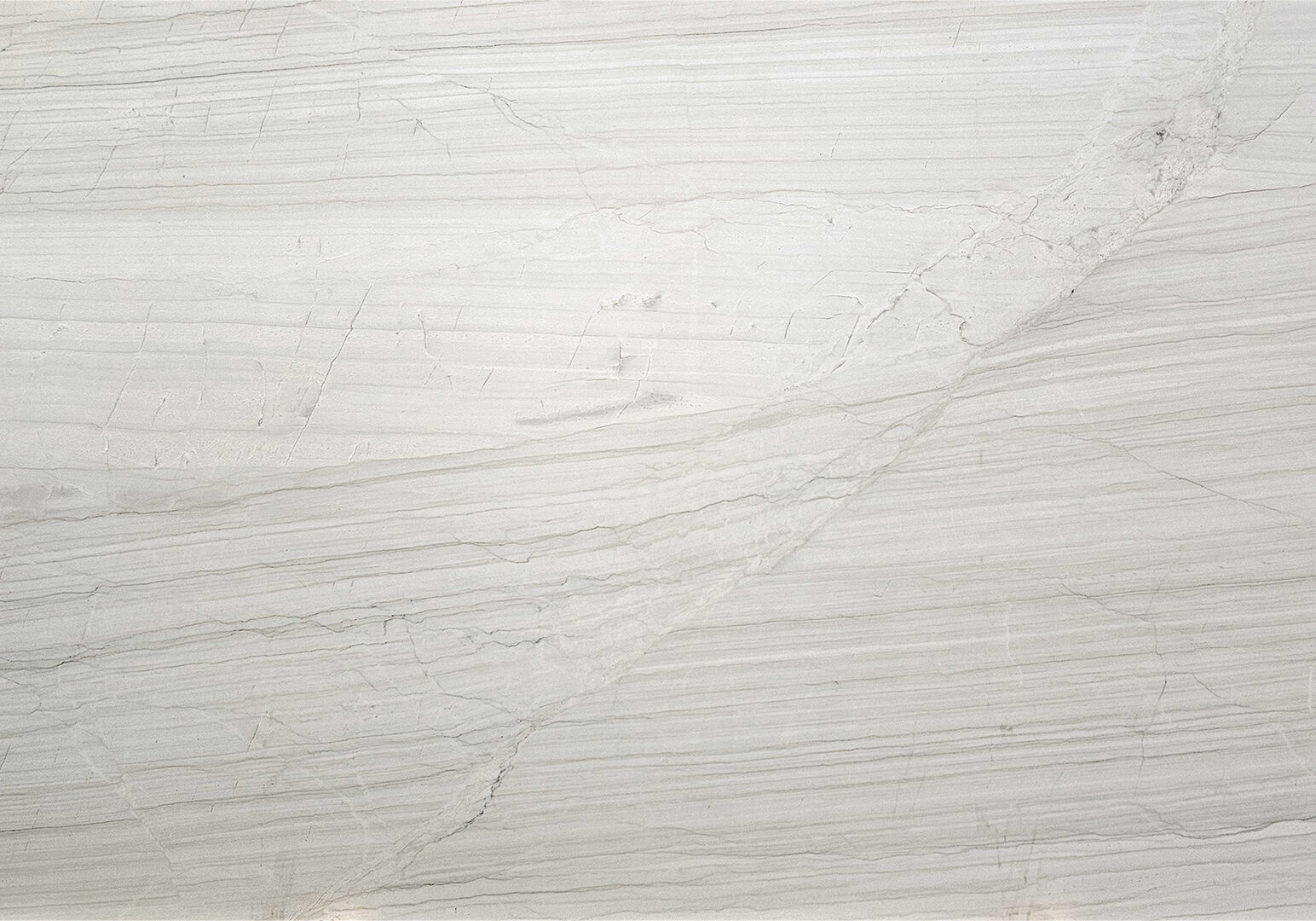 Full view of a White Lux Quartzite slab showcasing its bright white background and elegant fluid movement.