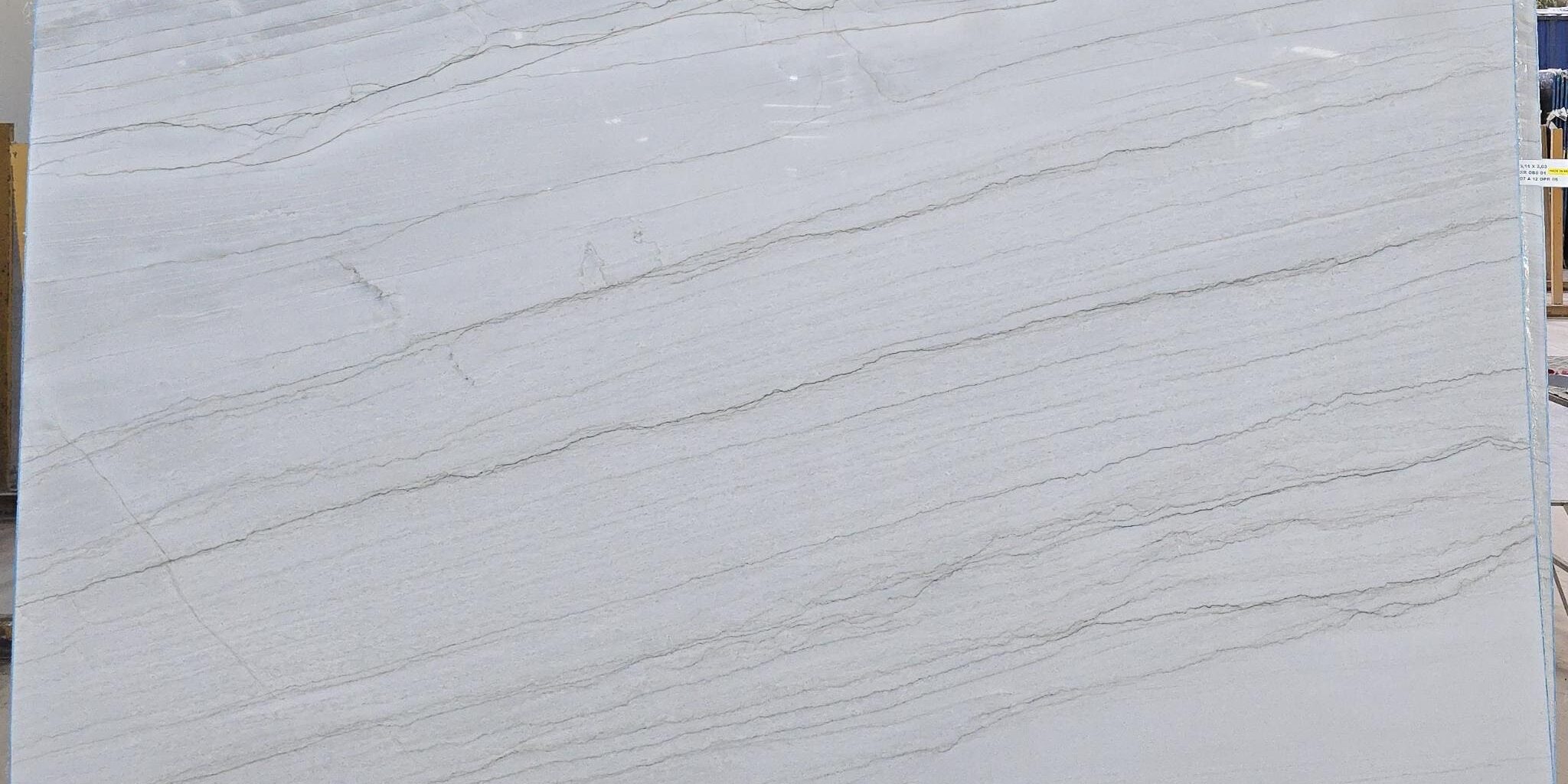Full look at a premium white stone slab displaying consistent, tight linear veins from edge to edge.