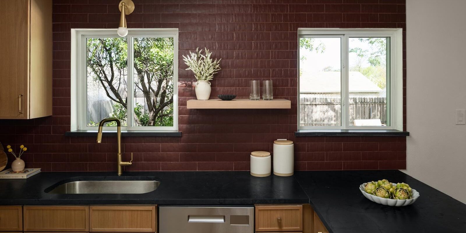Contemporary kitchen with a dark stone countertop featuring natural textures and a sophisticated matte look.