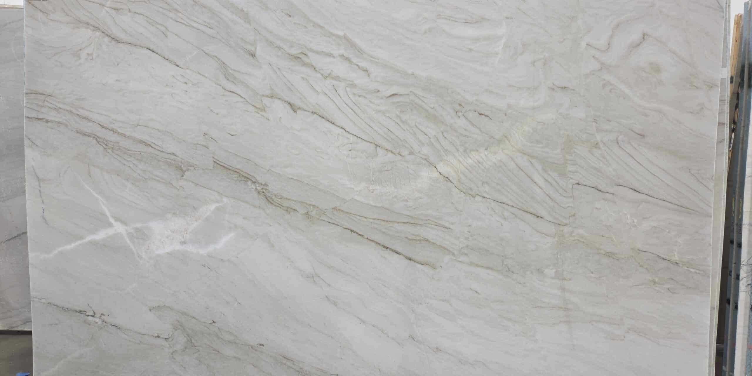 A large-scale look at a premium quartzite bundle displaying an elegant, fluid horizontal grain structure.