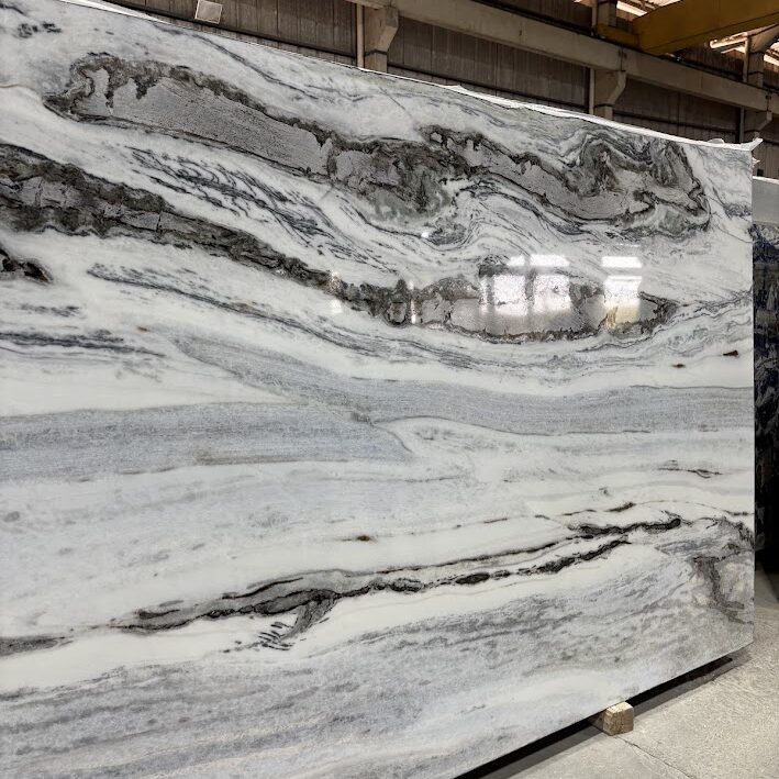 Full view of a polished White & Steel slab showcasing its dramatic horizontal gray structures and clean white field.
