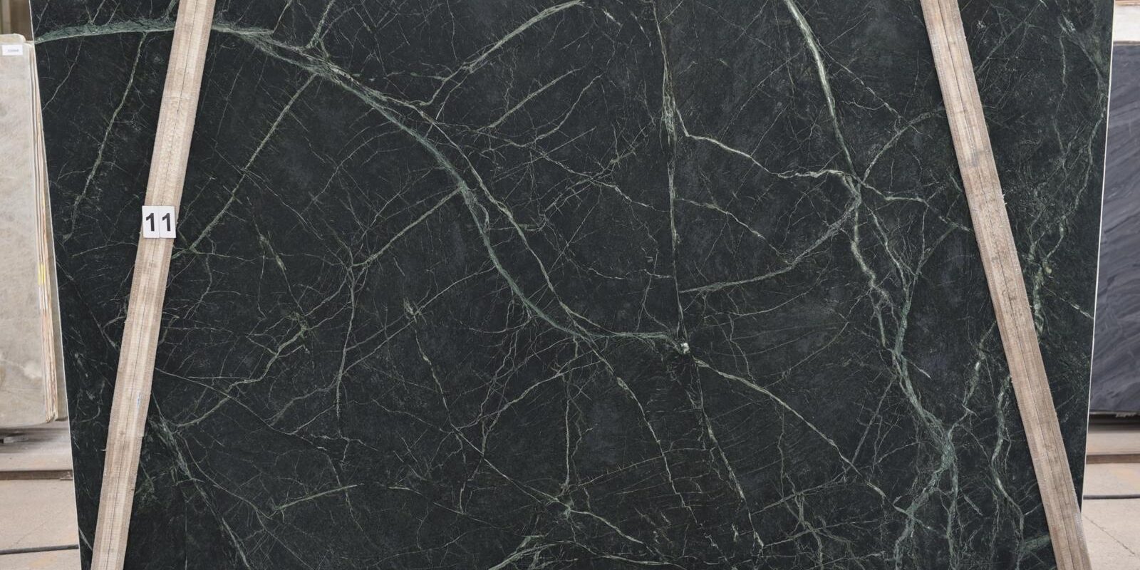 Full slab view of xingu brazilian quartzite showcasing its intense green color and dramatic organic movement.